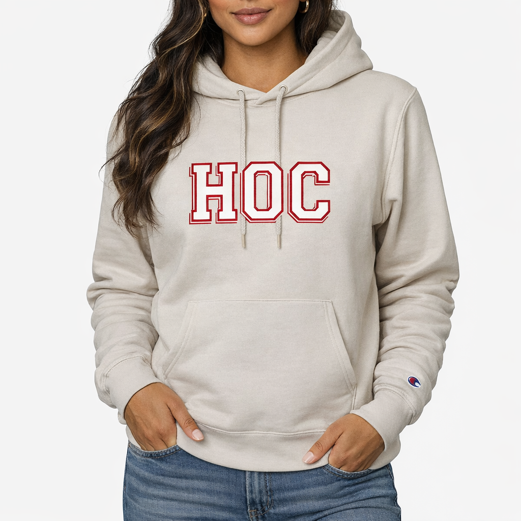 Beige hoodie with 'HOC' text worn by a person on a white background